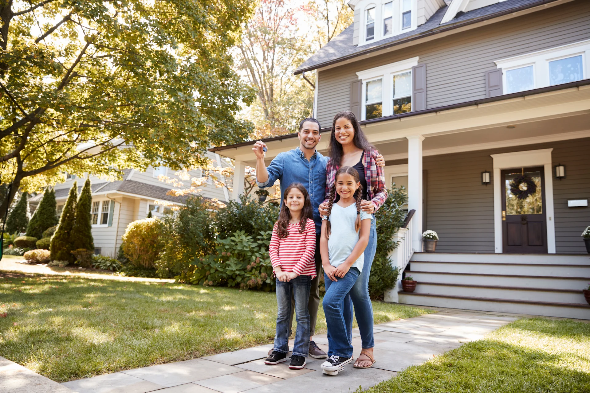 Family outside their home representing mortgage and finance services in Parramatta NSW by Greater Parramatta Finance